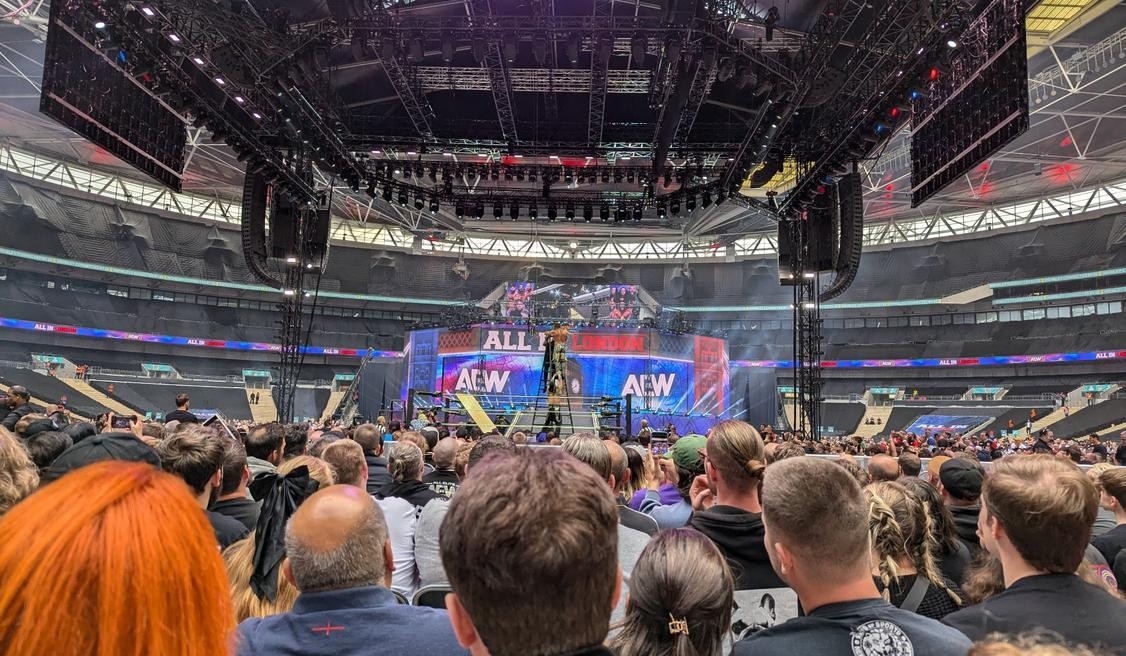 Christian Cage, Buddy Matthews, and Luchasaurus fighting on a ladder