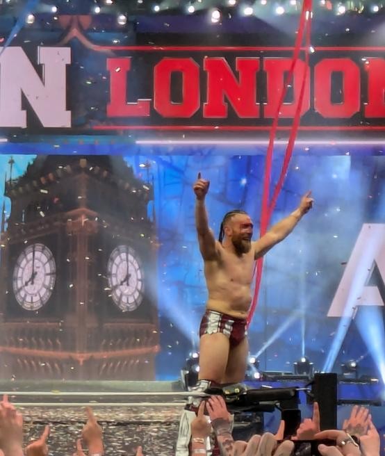 A bloodied Bryan Danielson makes the 'Yes!' gesture to the Wembley crowd