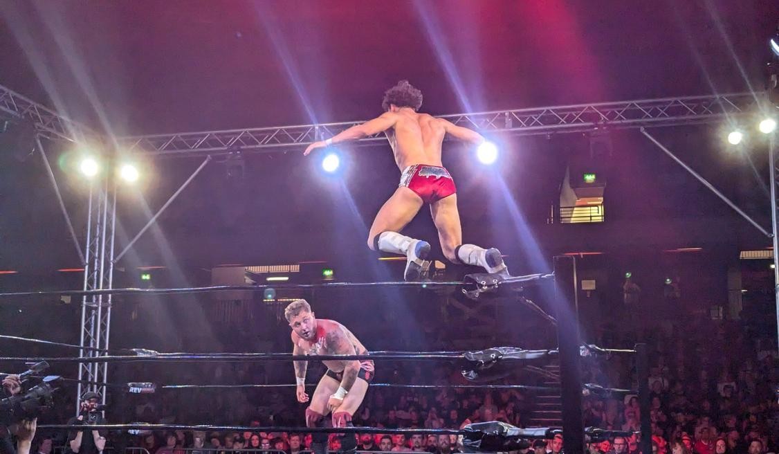Zozaya leaping from the turnbuckle onto Ricky Knight Jr.
