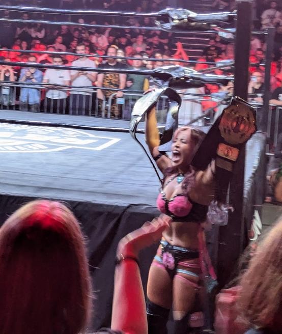 Mina Shirakawa celebrates ringside with both titles