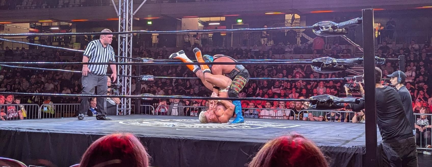 Zack Sabre Jr. wrenching Hechicero's arm into a submission