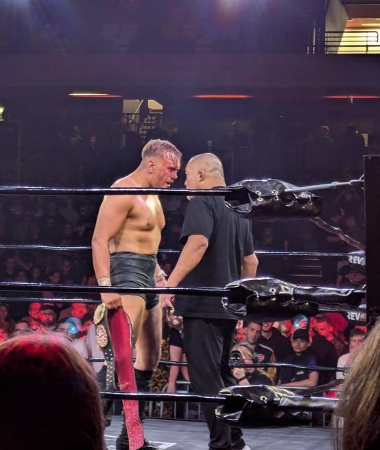 A bloodied Luke Jacobs holds the RevPro Undisputed British Heavyweight Title and stares down Tomohiro Ishii